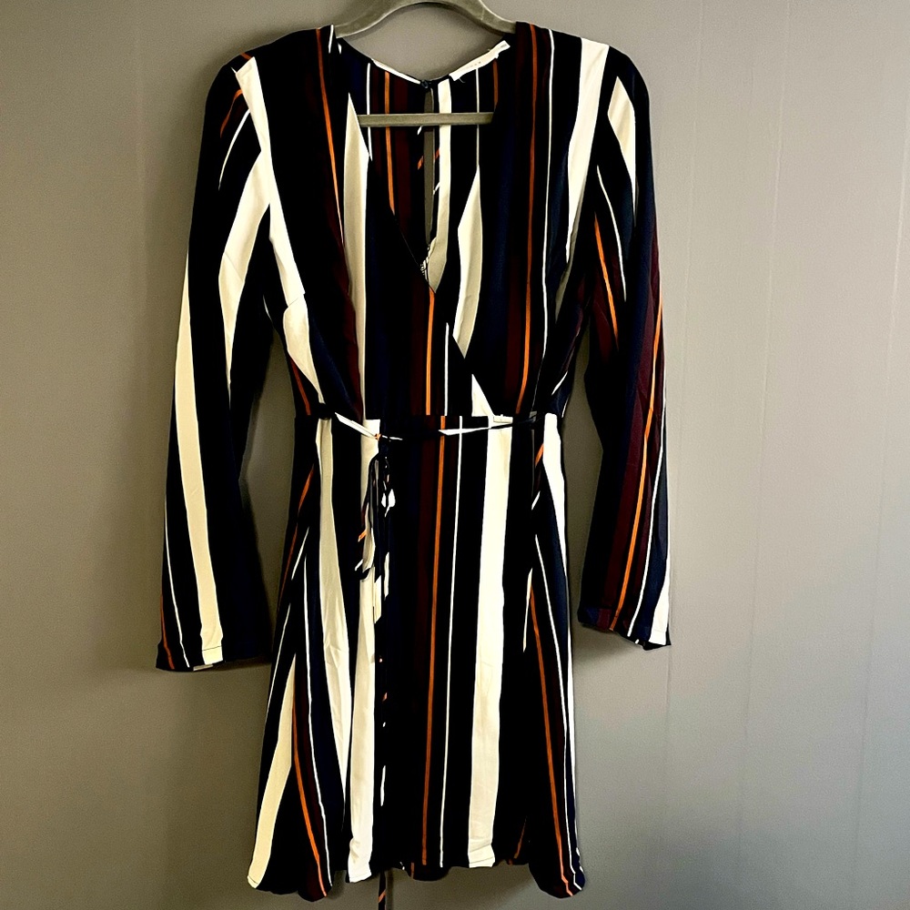 A day-to-night dress features long bell sleeve & a gathered tie waist.